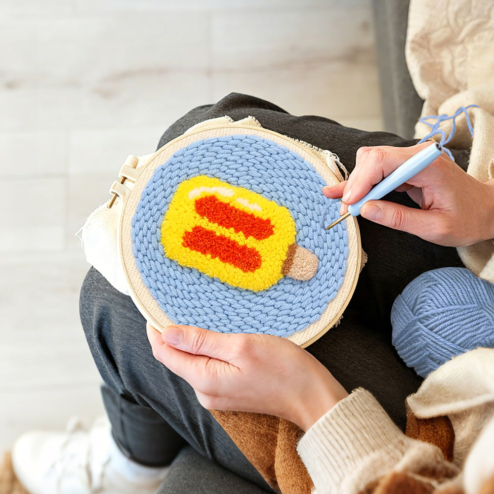 Creating handmade yellow and red ice lolly punch needle artwork