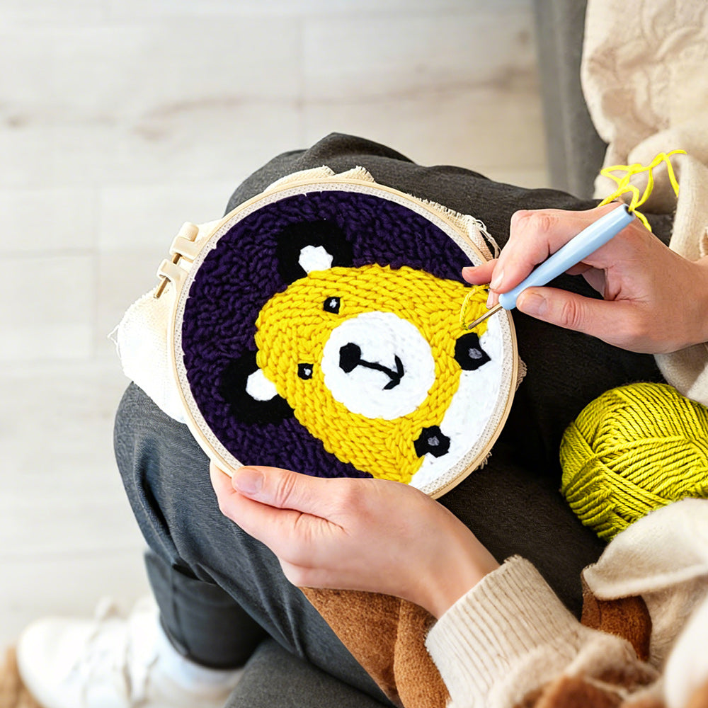 Creating handmade yellow bear face punch needle artwork