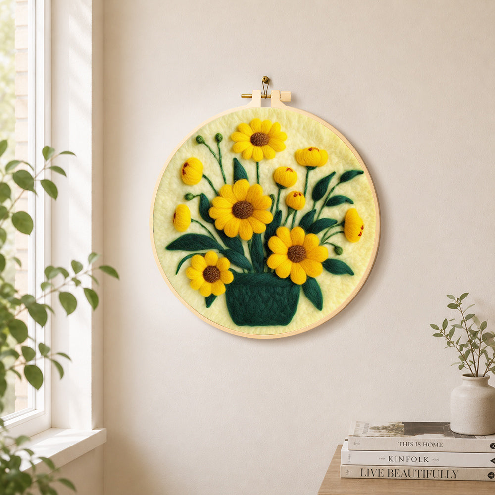 Yellow daisies in dark green vase needle felt wall art displayed in a bright home interior