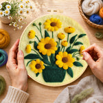 Creating the yellow daisies in dark green vase wool painting by hand with a felting needle