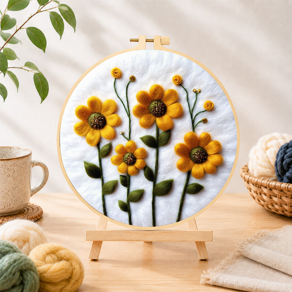 Finished yellow daisies with green stamens needle felting displayed on a wooden easel