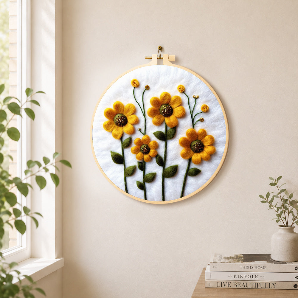 Yellow daisies with green stamens needle felt wall art displayed in a bright home interior