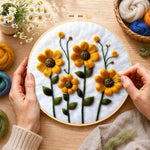 Creating the yellow daisies with green stamens wool painting by hand with a felting needle