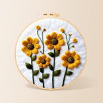Yellow daisies with green stamens needle felting kit for beginners with a round wooden frame