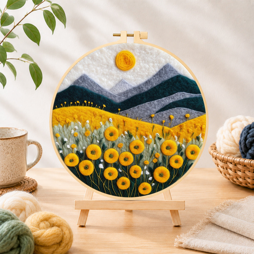 Finished yellow flower field with mountains needle felting displayed on a wooden easel