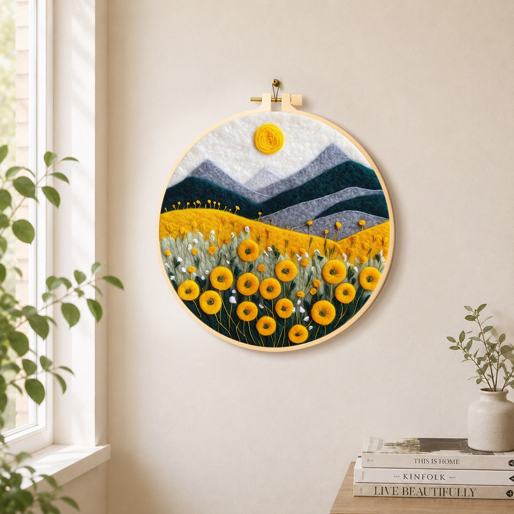 Yellow flower field with mountains needle felt wall art displayed in a bright home interior