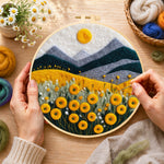 Creating the yellow flower field with mountains wool painting by hand with a felting needle