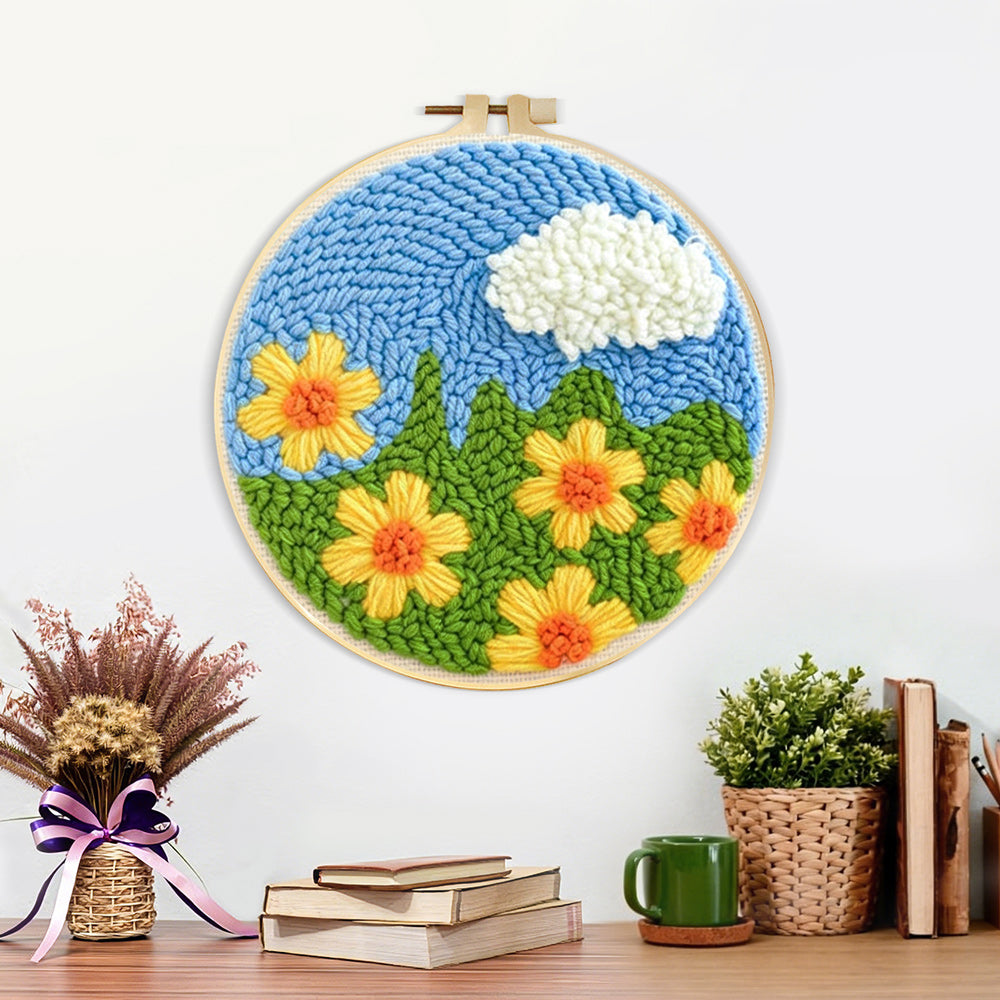 Finished yellow flowers under a cloud artwork displayed on a wall