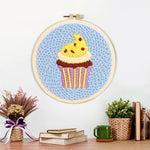 Finished yellow frosting cupcake artwork displayed on a wall