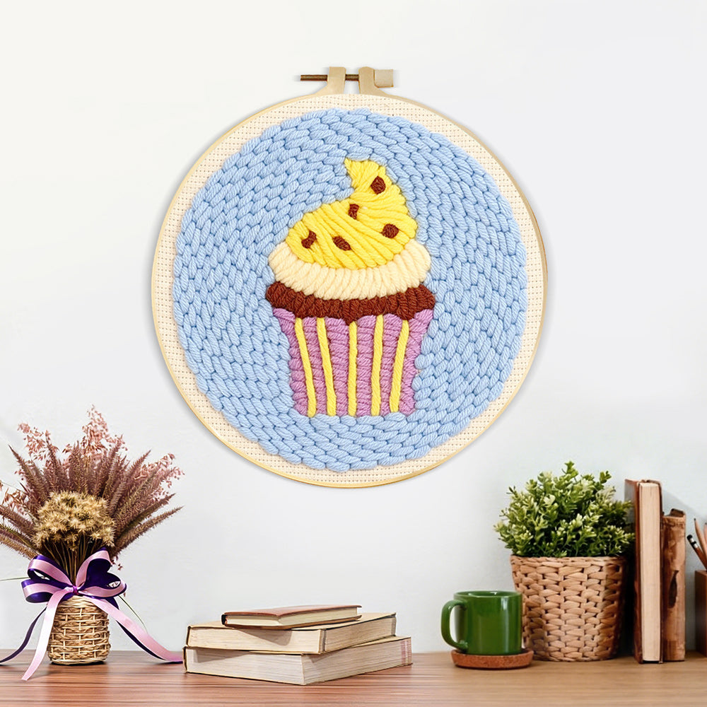 Finished yellow frosting cupcake artwork displayed on a wall