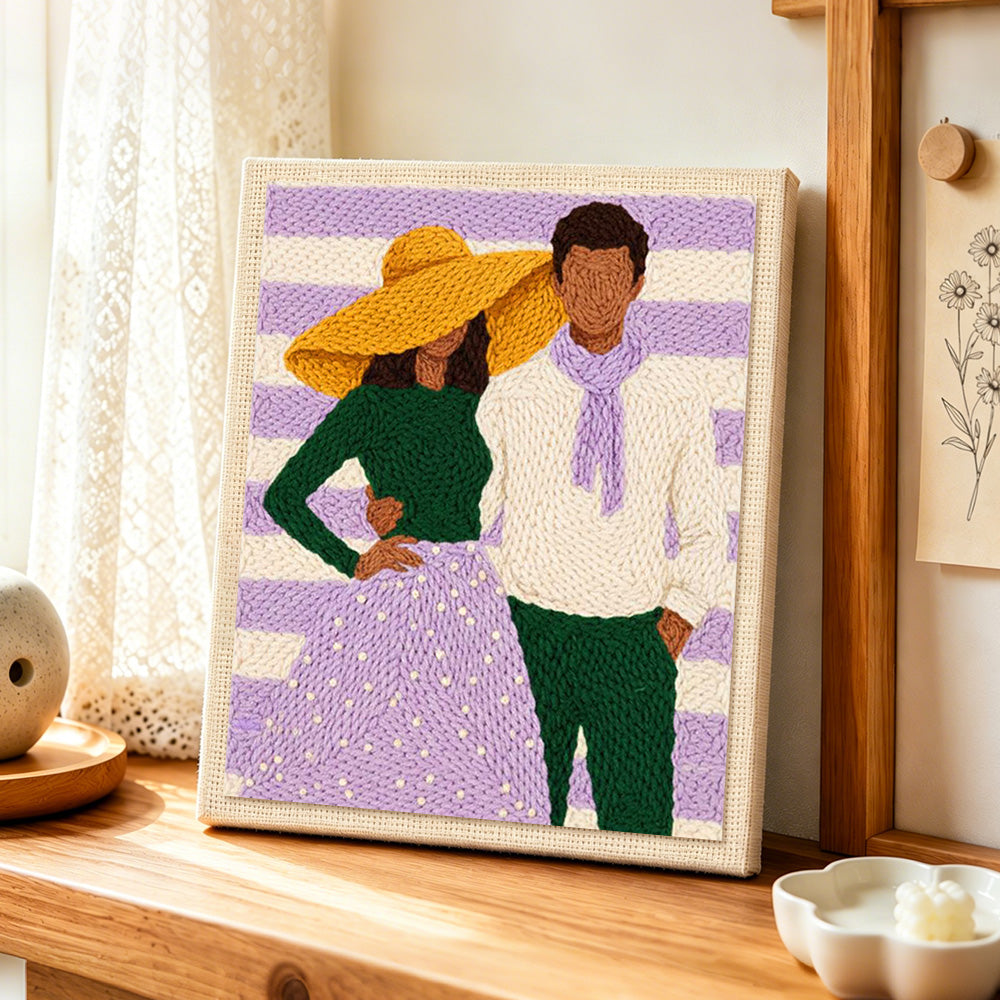 Yellow hat lady and scarf man punch needle artwork displayed on a table