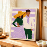 Yellow hat lady and scarf man punch needle artwork displayed on a table