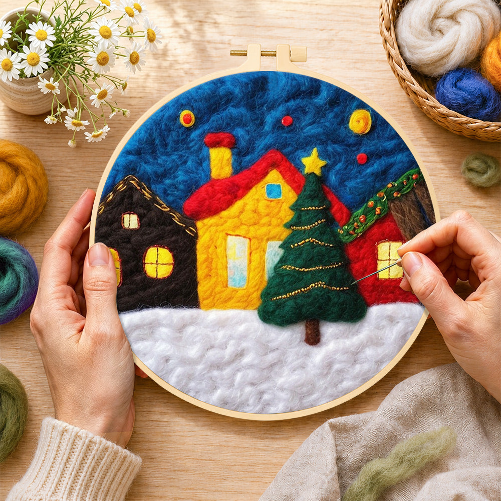 Creating the yellow house and christmas tree in snowy village wool painting by hand with a felting needle