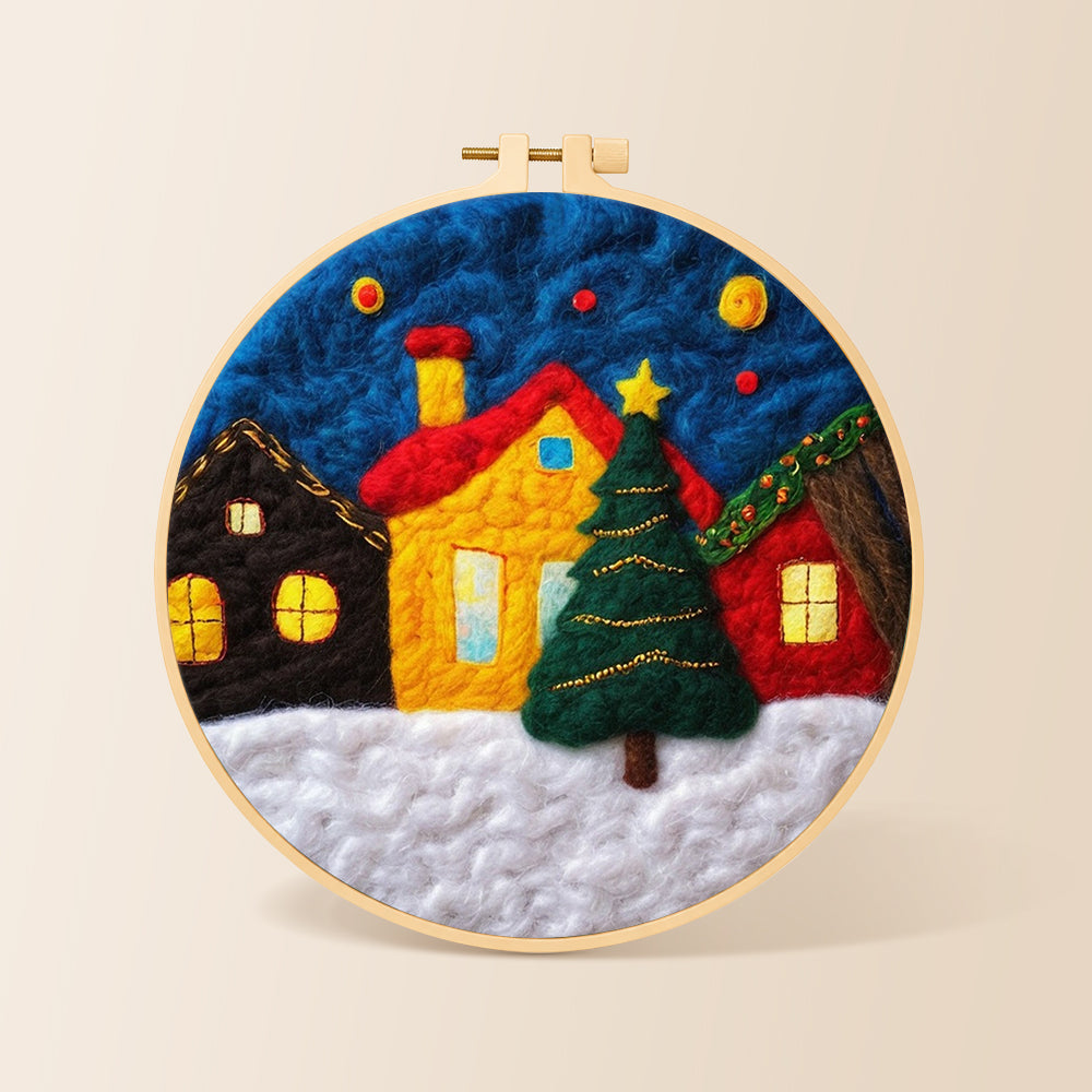 Yellow house and christmas tree in snowy village needle felting kit for beginners with a round wooden frame