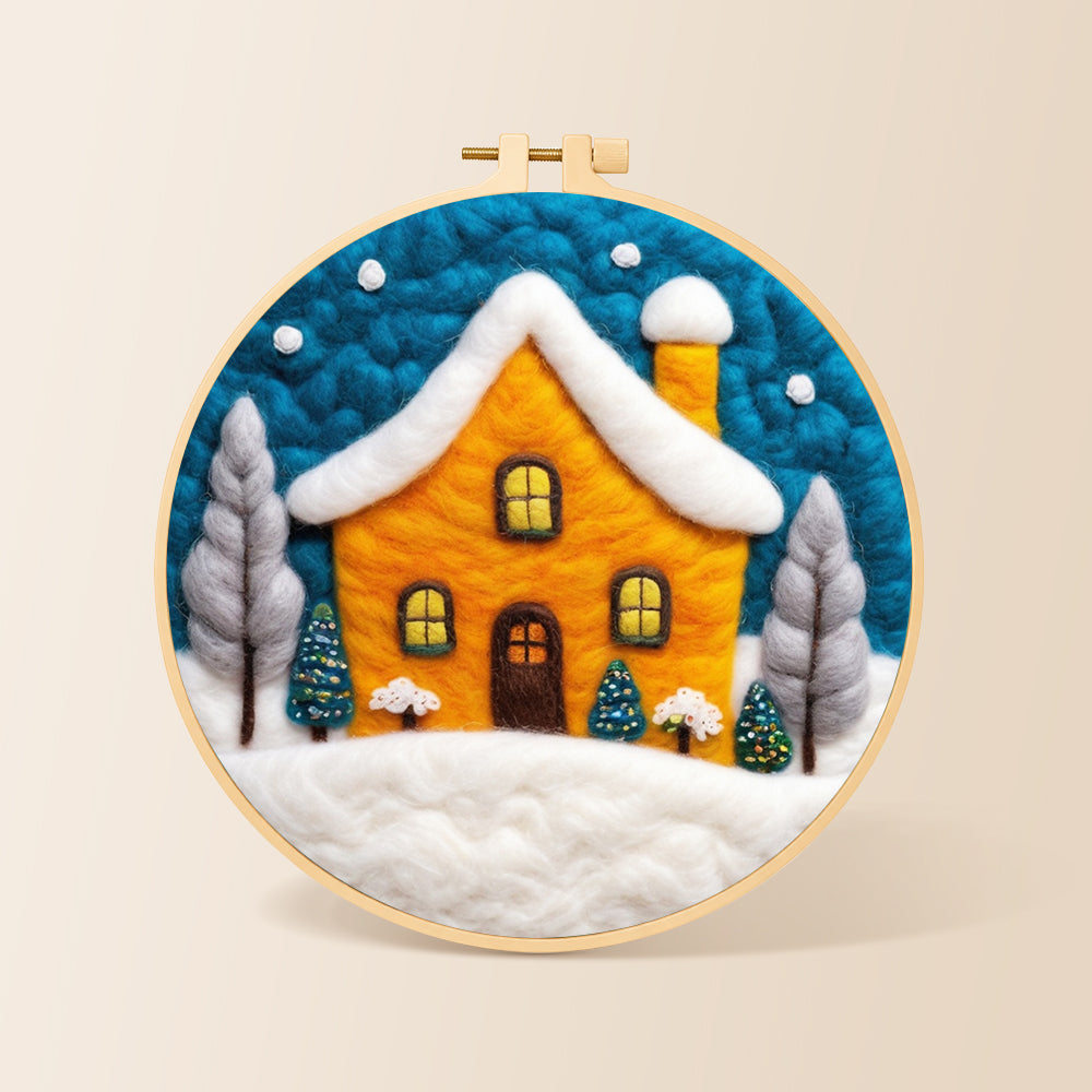 Yellow house glowing in the blue snowy night needle felting kit for beginners with a round wooden frame
