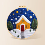 Yellow house with snowy path needle felting kit for beginners with a round wooden frame
