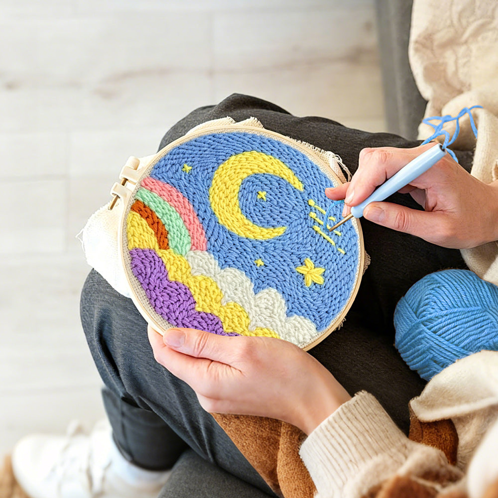 Creating handmade yellow moon, colourful clouds and rainbow punch needle artwork