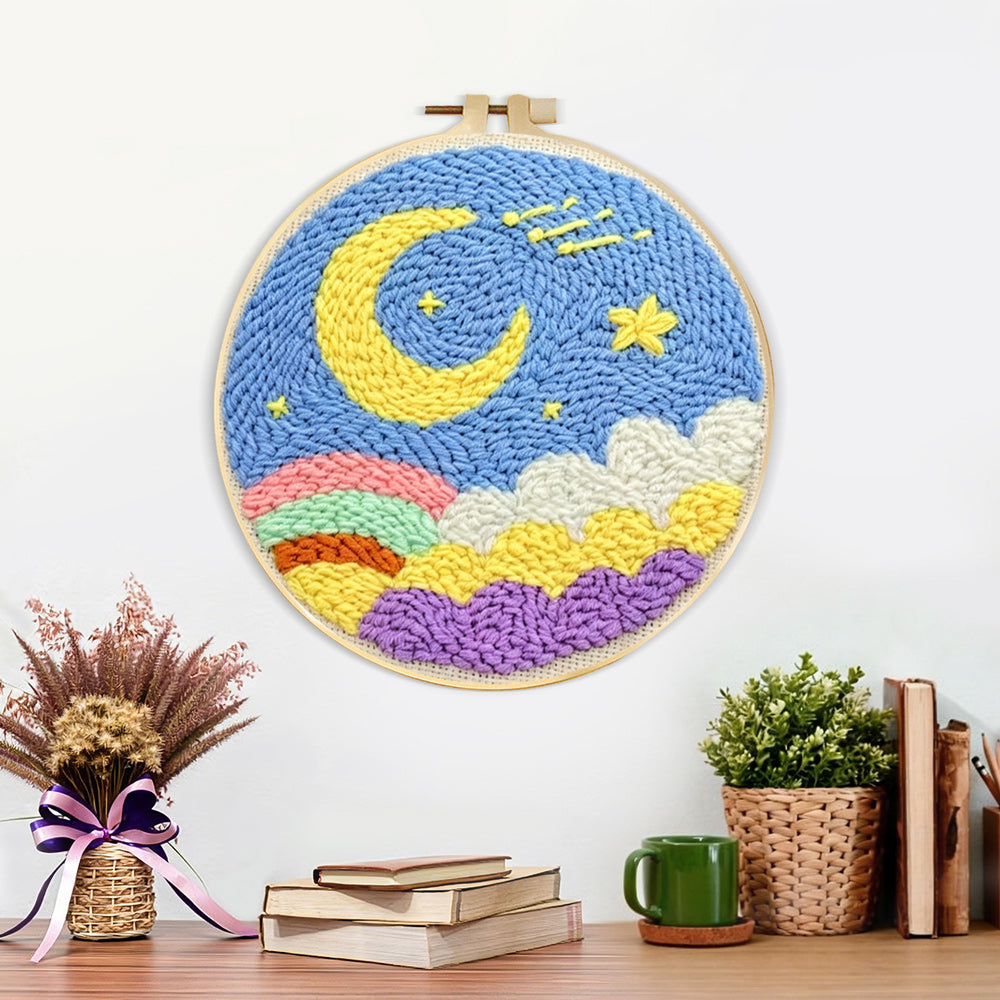 Finished yellow moon, colourful clouds and rainbow artwork displayed on a wall