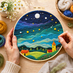 Creating the yellow tower house and rolling green clouds wool painting by hand with a felting needle