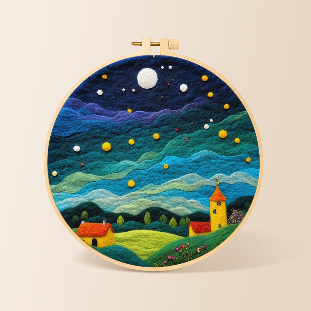 Yellow tower house and rolling green clouds needle felting kit for beginners with a round wooden frame