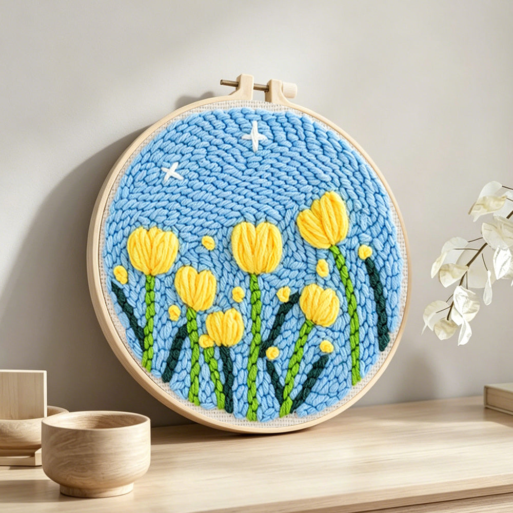 Yellow tulips under starry sky punch needle artwork displayed on a table