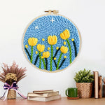 Finished yellow tulips under starry sky artwork displayed on a wall