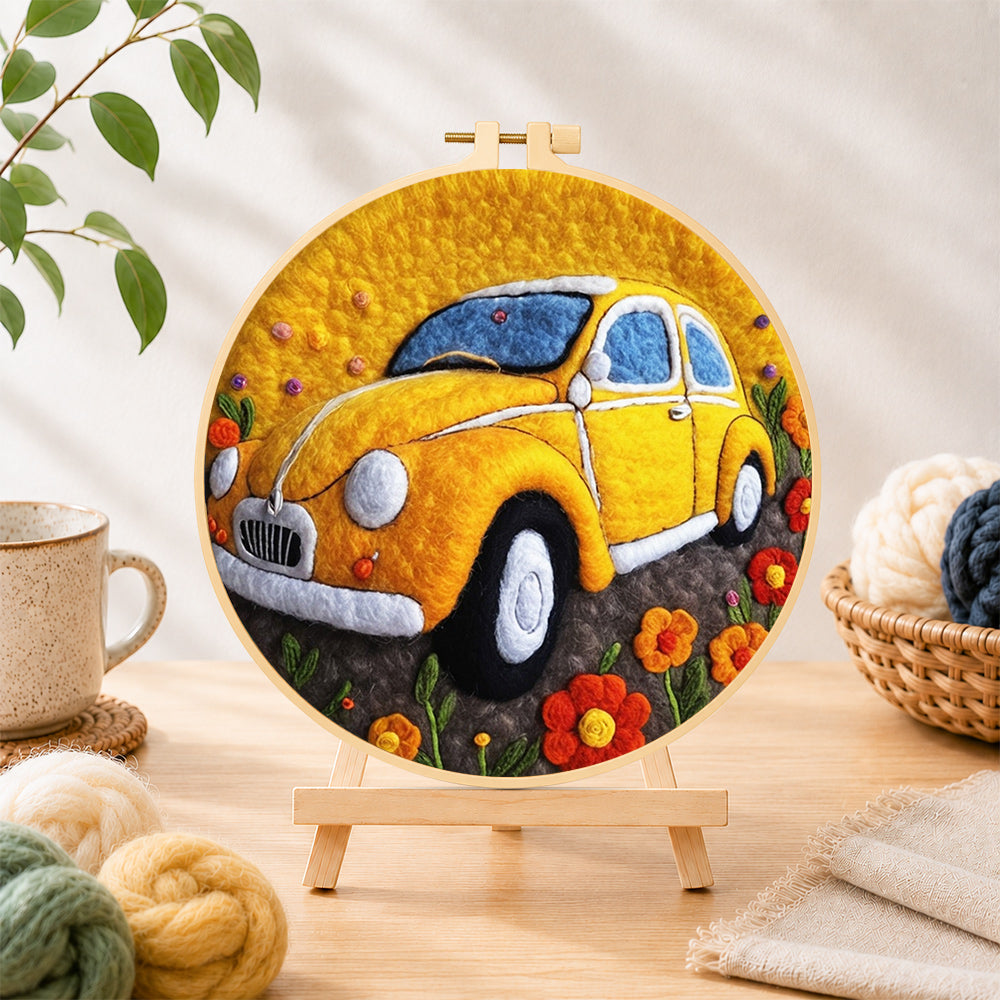 Finished yellow vintage car needle felting displayed on a wooden easel