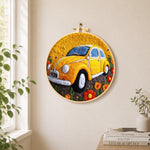 Yellow vintage car needle felt wall art displayed in a bright home interior